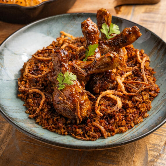Hasawi Rice | رز حساوي Red Hasawi rice from the Al-Ahsa oases, served with butter and date molasses glazed chicken drumsticks.